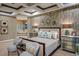 Spacious primary bedroom with a tray ceiling, accent wall, decorative pillows, and ensuite bathroom access at 17673 E Bronco Dr, Queen Creek, AZ 85142