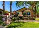 Relaxing outdoor patio with stone fireplace, lounge seating, and manicured shrubs at 17673 E Bronco Dr, Queen Creek, AZ 85142