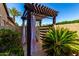 Private outdoor shower with pergola and tropical landscaping at 17673 E Bronco Dr, Queen Creek, AZ 85142