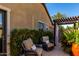 Relaxing outdoor patio with comfortable wicker chairs and lush greenery at 17673 E Bronco Dr, Queen Creek, AZ 85142
