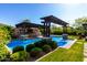 Stunning pool area with swim-up bar, pergola, and outdoor kitchen at 17673 E Bronco Dr, Queen Creek, AZ 85142