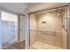 An elegant glass shower with tiled walls stands beside the open walk-in closet at 1871 Leisure World --, Mesa, AZ 85206