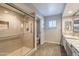 Updated bathroom with glass shower, granite countertops and ample cabinet storage at 1871 Leisure World --, Mesa, AZ 85206