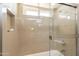A tiled shower over tub combo is brightly lit by a window for showering convenience at 1871 Leisure World --, Mesa, AZ 85206