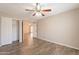 This spacious bedroom features wood-look floors, a ceiling fan, and a double-door closet at 1871 Leisure World --, Mesa, AZ 85206