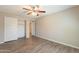 This bedroom offers wood-look flooring, a ceiling fan, and a sliding door closet at 1871 Leisure World --, Mesa, AZ 85206