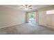 Bedroom with sliding glass door to patio, ceiling fan, and closet space at 1871 Leisure World --, Mesa, AZ 85206