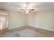 Bedroom with ceiling fan, neutral carpet and walls, and entrance to bathroom and closet at 1871 Leisure World --, Mesa, AZ 85206