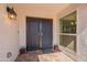 Close-up of the front door, featuring double doors and a decorative lamp post at 1871 Leisure World --, Mesa, AZ 85206
