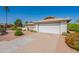Attractive one-story home with well-manicured desert landscaping, a long driveway, and a two-car garage at 1871 Leisure World --, Mesa, AZ 85206