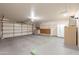 Spacious garage with epoxy flooring, overhead lighting, storage cabinets, and refrigerator at 1871 Leisure World --, Mesa, AZ 85206