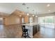 Spacious kitchen with granite island, modern lighting, and a seamless flow to the living area at 1871 Leisure World --, Mesa, AZ 85206