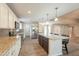 Modern kitchen with white cabinets, stainless steel appliances and granite countertops overlooks living area at 1871 Leisure World --, Mesa, AZ 85206