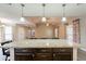 Open kitchen with granite island countertop and lighting fixtures overlooking the living room at 1871 Leisure World --, Mesa, AZ 85206