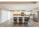Open kitchen boasts an island with granite countertop, stainless steel appliances and wood-style flooring at 1871 Leisure World --, Mesa, AZ 85206