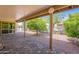 Covered patio with brick pavers overlooks fruit trees and gravel landscaping at 1871 Leisure World --, Mesa, AZ 85206