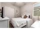 Cozy bedroom with white walls, carpet floors, a white bed, and natural light from the window at 19038 N Arbor Dr, Maricopa, AZ 85138