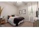 Inviting bedroom featuring a queen-sized bed, modern decor, and natural lighting at 19038 N Arbor Dr, Maricopa, AZ 85138