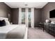 Charming bedroom featuring a queen-sized bed, modern decor, and natural light at 19038 N Arbor Dr, Maricopa, AZ 85138