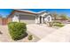 Charming home with a well-manicured yard, tile roof, desert landscaping and a paver driveway at 19038 N Arbor Dr, Maricopa, AZ 85138