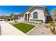 Attractive home with a tile roof, desert landscaping, an arched window and a paver driveway at 19038 N Arbor Dr, Maricopa, AZ 85138