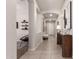Bright hallway featuring tiled floors, neutral paint, and stylish decorative accents at 19038 N Arbor Dr, Maricopa, AZ 85138