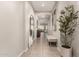 Inviting hallway with neutral tones, elegant decor, and a view to the living area at 19038 N Arbor Dr, Maricopa, AZ 85138