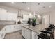 Bright kitchen featuring granite countertops, white cabinets, and a stainless steel oven at 19038 N Arbor Dr, Maricopa, AZ 85138