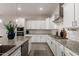 Bright kitchen featuring granite countertops, white cabinets, and a stainless steel oven at 19038 N Arbor Dr, Maricopa, AZ 85138