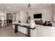 Open-concept living area with a modern sofa, large TV, and contemporary decor at 19038 N Arbor Dr, Maricopa, AZ 85138