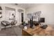 Comfortable home office featuring a gray couch, decorative shelves, and modern decor at 19038 N Arbor Dr, Maricopa, AZ 85138