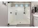 Beautiful walk-in shower with a sleek glass door and double shower heads at 19038 N Arbor Dr, Maricopa, AZ 85138