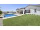 A full view of this well manicured backyard shows artificial turf, pool with waterfall, and outdoor dining at 2153 E Cherrywood Pl, Chandler, AZ 85249