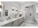 Bright bathroom features double sinks, glass shower enclosure, and soaking tub at 2153 E Cherrywood Pl, Chandler, AZ 85249