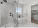 Bathroom with glass shower enclosure, freestanding tub, and walk-in closet at 2153 E Cherrywood Pl, Chandler, AZ 85249