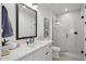 Elegant bathroom featuring a white vanity, sleek fixtures, and a glass-enclosed shower with white tiles for a spa-like feel at 2153 E Cherrywood Pl, Chandler, AZ 85249