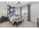 Well-lit bedroom with baseball themed wall art, bench at the end of the bed, and a large window at 2153 E Cherrywood Pl, Chandler, AZ 85249