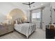 Stylish bedroom with a unique half-circle wall design, modern furniture, and plenty of natural light from the large window at 2153 E Cherrywood Pl, Chandler, AZ 85249