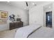 Spacious bedroom featuring modern decor, a stylish dresser, and a glimpse into the ensuite bathroom at 2153 E Cherrywood Pl, Chandler, AZ 85249