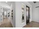 Inviting hallway featuring hardwood floors, leading to a modern living space with lots of light from the windows at 2153 E Cherrywood Pl, Chandler, AZ 85249