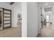 Bright hallway features hardwood floors, white walls, and doors to other rooms at 2153 E Cherrywood Pl, Chandler, AZ 85249