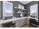Home office with designer wallpaper, built-in desk, dual windows, and ample light at 2153 E Cherrywood Pl, Chandler, AZ 85249