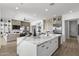 Open kitchen featuring a marble island, stainless steel appliances, and seamless flow to the living area at 2153 E Cherrywood Pl, Chandler, AZ 85249