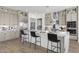 Elegant kitchen with a marble island, stainless steel appliances, and custom cabinets with glass inserts at 2153 E Cherrywood Pl, Chandler, AZ 85249