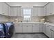 Laundry room features front loading washer and dryer, quartz countertops, and ample storage at 2153 E Cherrywood Pl, Chandler, AZ 85249