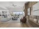 Open-concept living room with hardwood floors, fireplace, and sliding glass doors to pool area at 2153 E Cherrywood Pl, Chandler, AZ 85249