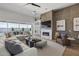 Inviting living room featuring a modern fireplace, built-in shelving, and views of the outdoor pool at 2153 E Cherrywood Pl, Chandler, AZ 85249