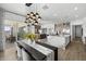 Open-concept living area featuring a kitchen with marble island, dining area, and large windows at 2153 E Cherrywood Pl, Chandler, AZ 85249