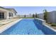 A sparkling blue swimming pool features a modern, zero-edge water feature and secure safety netting at 2153 E Cherrywood Pl, Chandler, AZ 85249