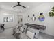 Stylish recreation room featuring cozy seating, a modern shuffleboard table, and ample space for relaxation and entertainment at 2153 E Cherrywood Pl, Chandler, AZ 85249